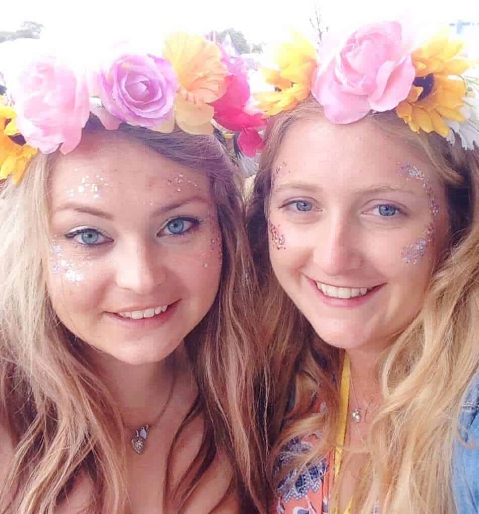 Girls wearing flower garland headbands Glastonbury
